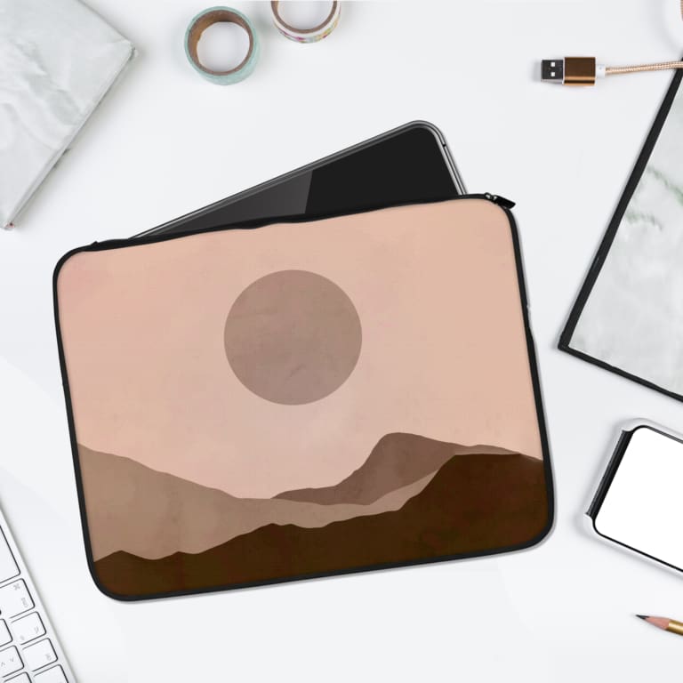 Minimalist laptop sleeve with a gray circle, brown wavy landscape pattern, and light beige background. laptop sleeve kept on a plain white background
