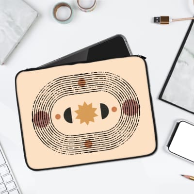 Laptop sleeve with a symmetrical sun-like design in earthy tones, featuring a circular pattern with shades of brown, beige, and orange. laptop sleeve kept on a plain white background