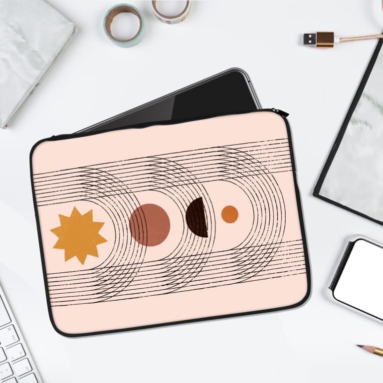 Infidu Celestial Sun and Moon Phases Laptop Sleeve with sun, moon phases, and concentric wave patterns in brown, black, and yellow. laptop sleeve kept on a plain white background