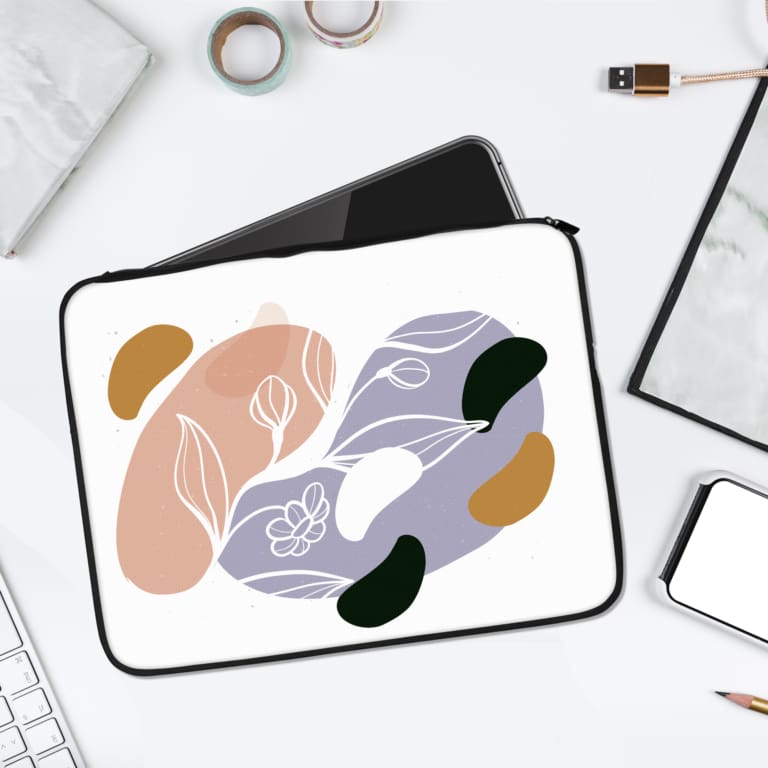 Laptop sleeve featuring an abstract pastel design with pink, blue, green, and yellow shapes on a white background, offering modern minimalist style. laptop sleeve kept on a plain white background