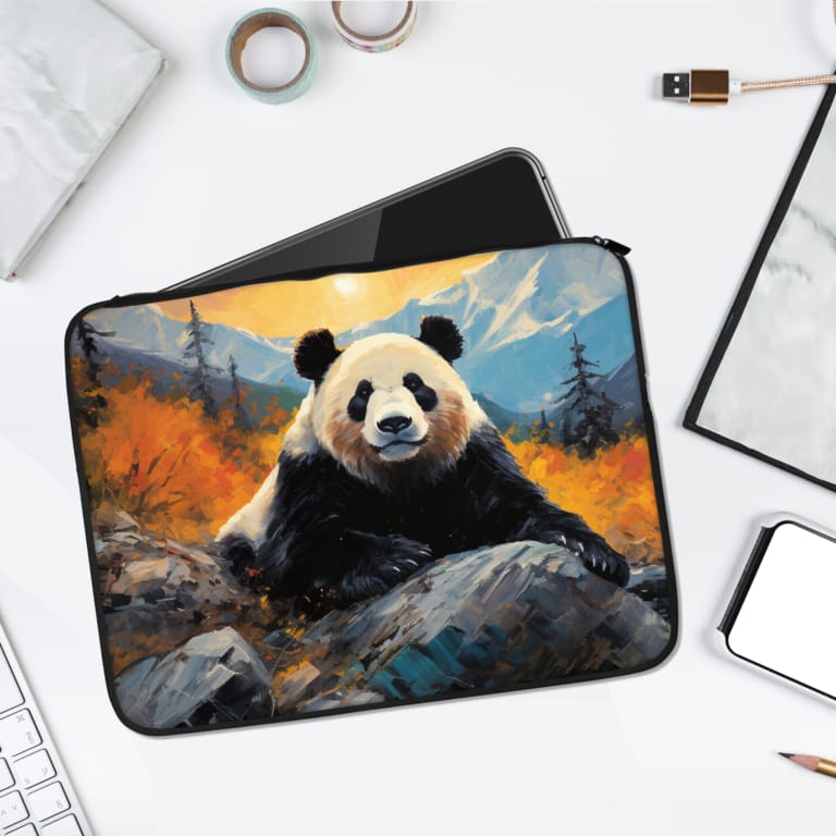 Peaceful panda wildlife laptop sleeve with a panda in an autumn forest, orange and yellow trees, mountains, and a partly cloudy sky. laptop sleeve kept on a plain white background