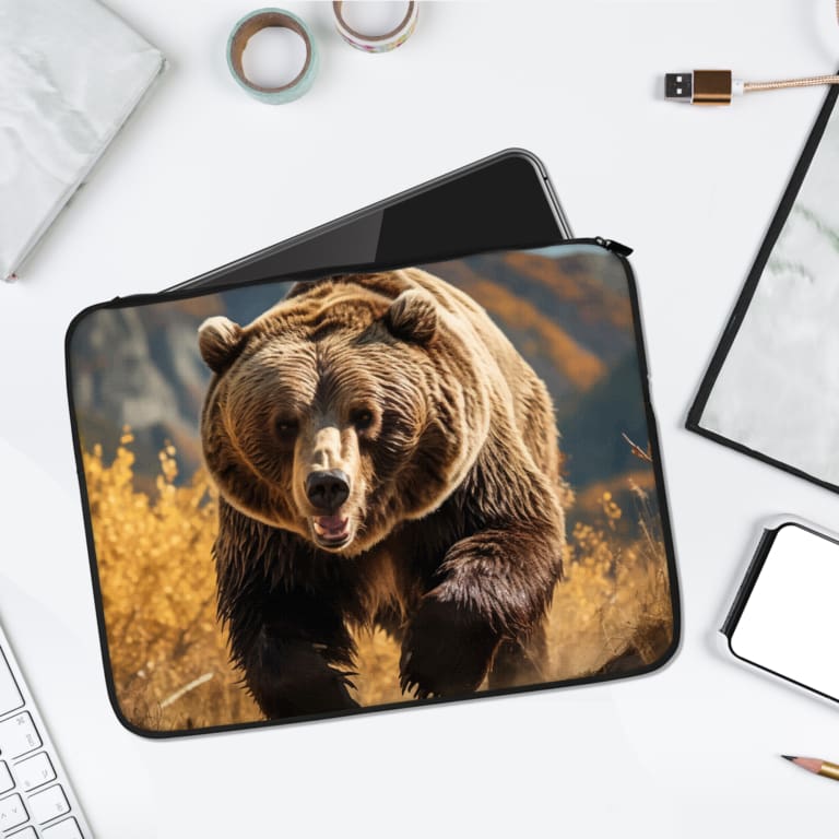 Realistic brown bear laptop sleeve with a natural forest scene and secure zip closure for stylish and durable laptop protection. laptop sleeve kept on a plain white background