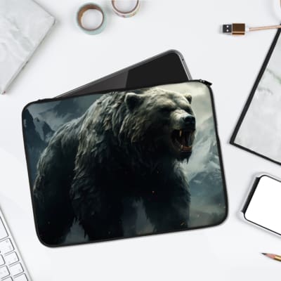 Laptop sleeve with a roaring bear design against snowy mountains in dark gray, black, and white tones. laptop sleeve kept on a plain white background