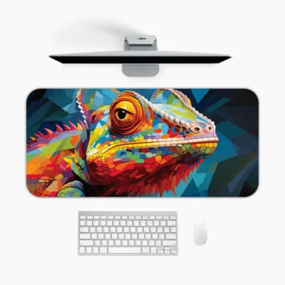 Colorful chameleon on a blue desk mat with vibrant orange, yellow, pink, and blue hues. A desk pad under the computer