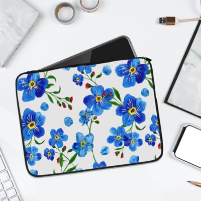 Infidu Floral Blue and Green Elegant Laptop Sleeve with blue flowers and green leaves on a white background. laptop sleeve kept on a plain white background