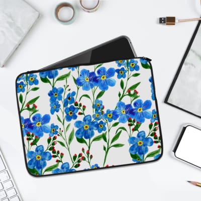 Infidu Vibrant Floral Pink and Blue Flower Laptop Sleeve with bright blue flowers, pink flower buds, and green leaves on a white background. laptop sleeve kept on a plain white background