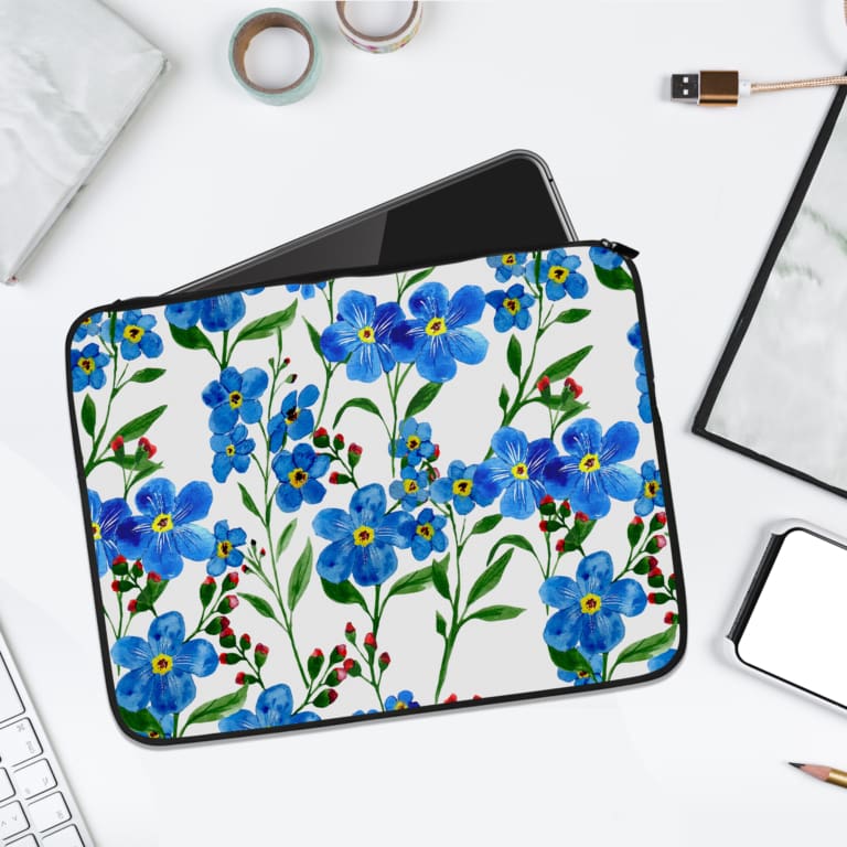 Infidu Vibrant Floral Pink and Blue Flower Laptop Sleeve with bright blue flowers, pink flower buds, and green leaves on a white background. laptop sleeve kept on a plain white background
