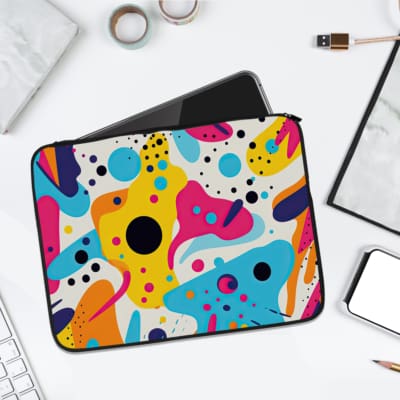 Infidu Bold Abstract Colorful Laptop Sleeve featuring vibrant blue, yellow, pink, black, and white abstract patterns on a white background. laptop sleeve kept on a plain white background