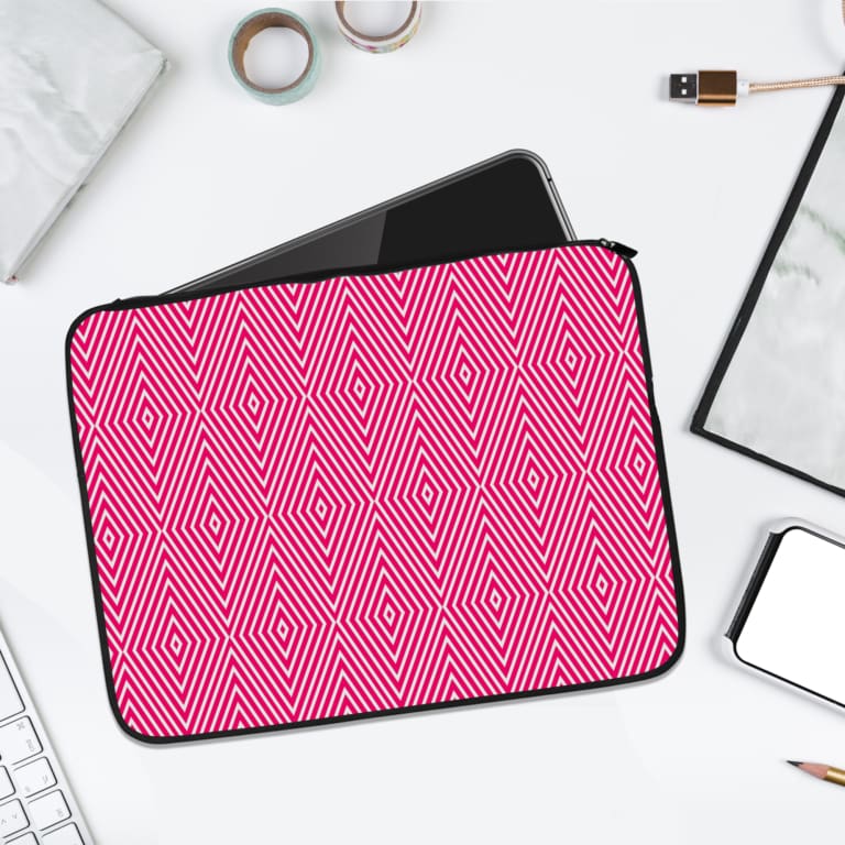 Pink laptop sleeve with bold white diamond geometric pattern, stylish and modern design. laptop sleeve kept on a plain white background
