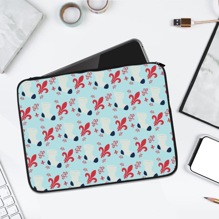 Light blue laptop sleeve with red and black floral patterns, designed for durability and style. laptop sleeve kept on a plain white background