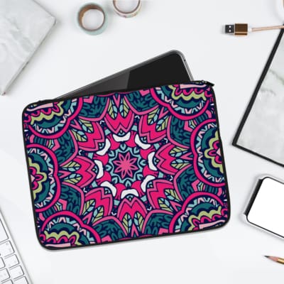 Laptop sleeve featuring a colorful, vibrant mandala pattern in pink, blue, and purple, made with durable fabric and a secure zip closure. laptop sleeve kept on a plain white background