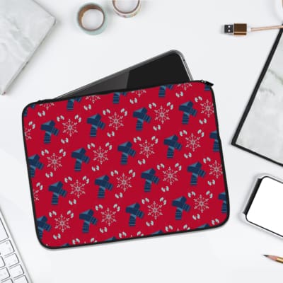 Infidu Red & Blue Snowflake Ribbon Laptop Sleeve with festive red background and blue ribbons, decorated with white snowflakes. laptop sleeve kept on a plain white background