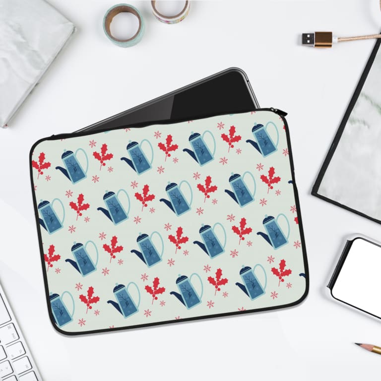 Laptop sleeve with a white background featuring a vibrant floral design of blue water jade and red flowers in an alternating pattern. laptop sleeve kept on a plain white background
