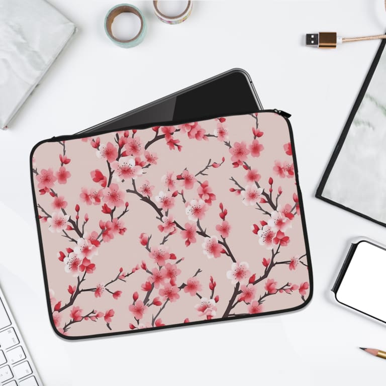 Infidu Soft Pink Floral Cherry Blossom Laptop Sleeve with delicate pink cherry blossoms on a soft pink background. laptop sleeve kept on a plain white background