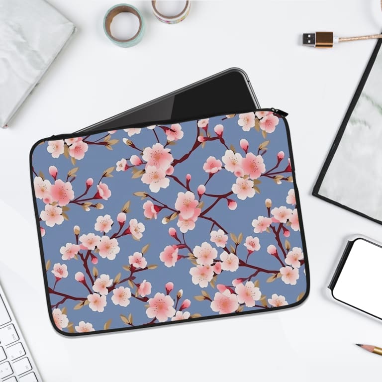 Infidu Elegant Cherry Blossom Floral Laptop Sleeve featuring pink cherry blossoms on branches with a soft blue background. laptop sleeve kept on a plain white background