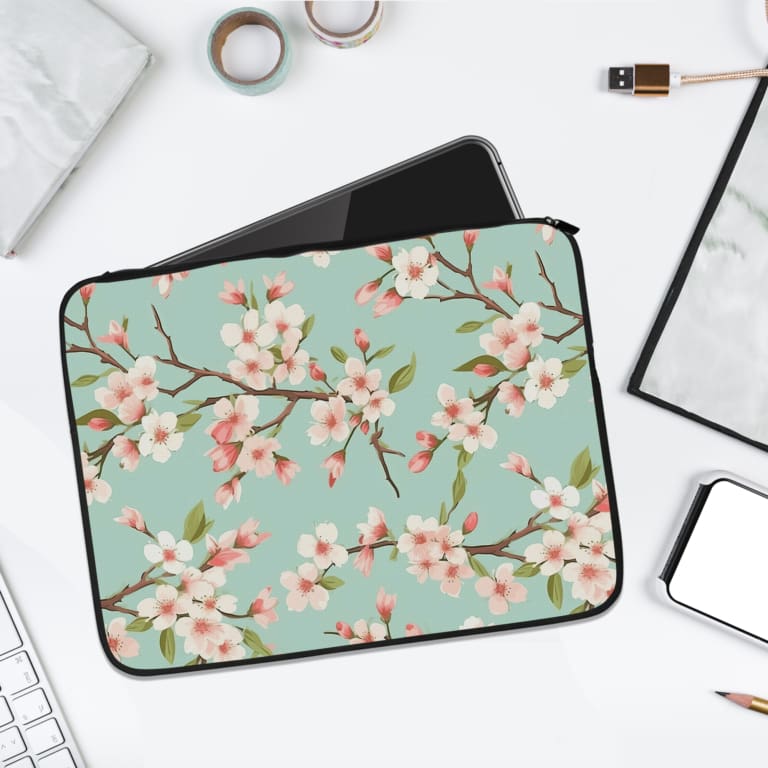 Infidu Soft Green Floral Blossom Laptop Sleeve with light pink blossoms and brown branches on a soft green background. laptop sleeve kept on a plain white background