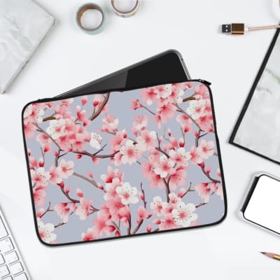 Infidu Elegant Cherry Blossom Floral Laptop Sleeve featuring pink cherry blossoms on branches with a soft blue background. laptop sleeve kept on a plain white background
