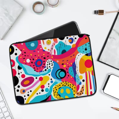 Laptop sleeve featuring an abstract multicolored design in blue, pink, yellow, and white, made with durable fabric and secure zip closure. laptop sleeve kept on a plain white background