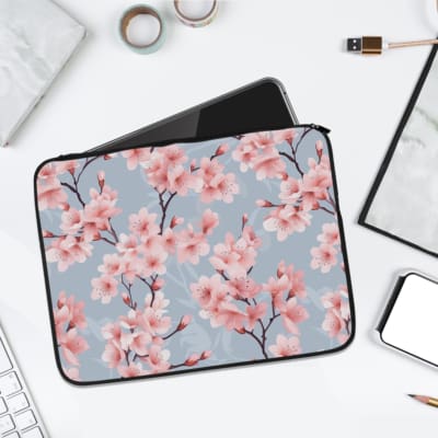 Infidu Pink Cherry Blossom Light Blue Laptop Sleeve with floral design featuring pink cherry blossoms on a light blue background. laptop sleeve kept on a plain white background