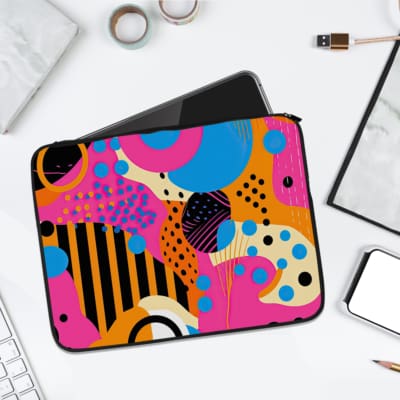 Infidu Vibrant Abstract Laptop Sleeve with bold geometric shapes in purple, yellow, blue, pink, and black. laptop sleeve kept on a plain white background