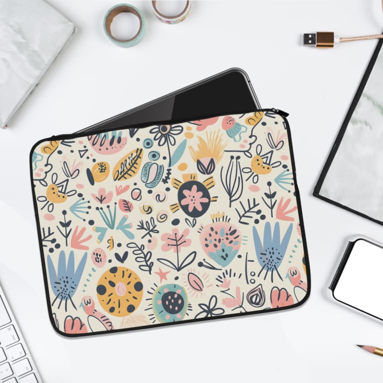 Pastel floral and botanical laptop sleeve with a white background and soft, colorful flower and leaf patterns. laptop sleeve kept on a plain white background