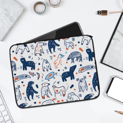 A white laptop sleeve with playful blue, white, and orange animal and abstract design, perfect for protecting and styling your laptop. laptop sleeve kept on a plain white background