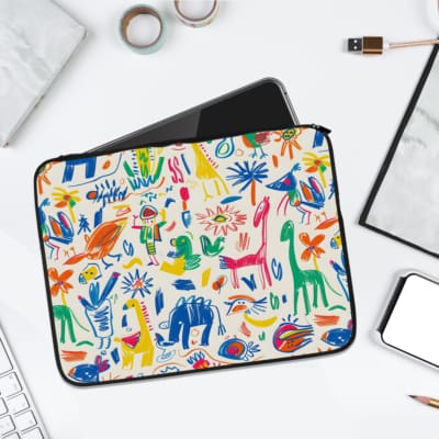 Laptop sleeve with playful abstract shapes, colorful animals, and plants on a white background, crafted with durable fabric and a secure zip. laptop sleeve kept on a plain white background