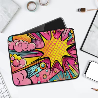 Colorful comic-style laptop sleeve with bright yellow, pink, purple, and blue explosive patterns, featuring stars, dots, and bubbles. laptop sleeve kept on a plain white background