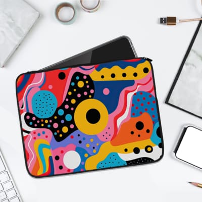Vibrant abstract design laptop sleeve with colorful patterns in yellow, blue, pink, and black, offering modern protection for your laptop. laptop sleeve kept on a plain white background
