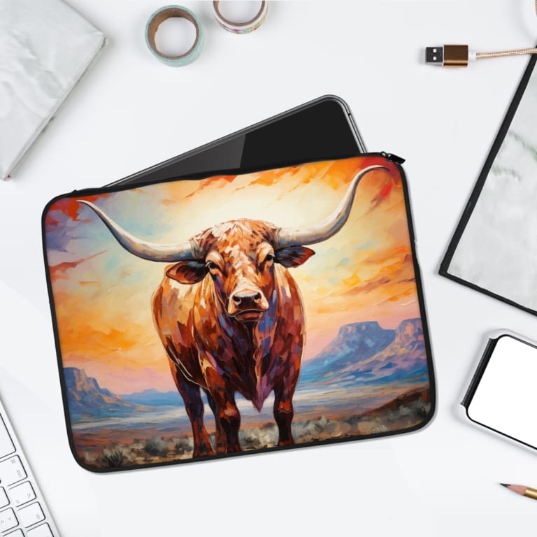 A vibrant laptop sleeve with a realistic bull painting, set against a scenic field with an orange and blue sky, featuring a secure zip closure. laptop sleeve kept on a plain white background