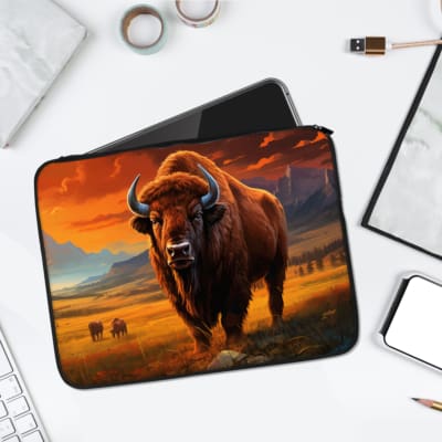 A bison-themed laptop sleeve with a sunset field design, featuring warm tones of orange, yellow, and brown, perfect for nature enthusiasts. Infidu Bison Laptop Sleeve with Sunset Field Design – Durable and Stylish Laptop Protection laptop sleeve kept on a plain white background