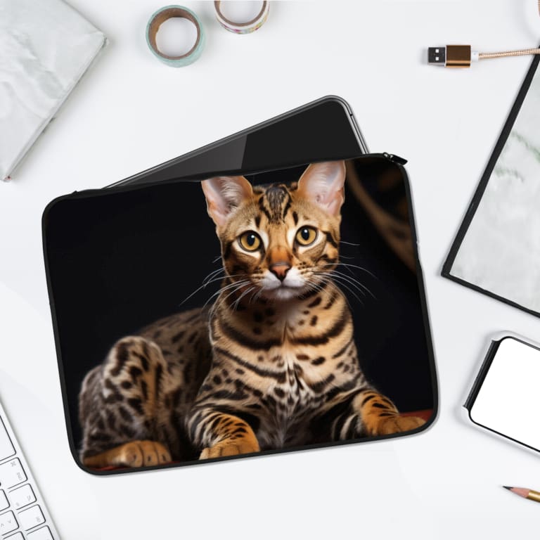 Laptop sleeve featuring a sleek Bengal cat with a spotted coat, made from durable fabric and a secure zip for stylish laptop protection. laptop sleeve kept on a plain white background