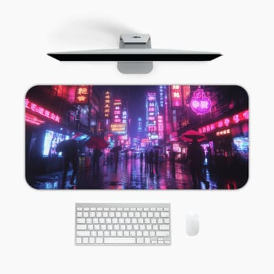 Infidu Neon Cityscape Desk Pad features a rainy night cityscape with vibrant neon lights in blue, pink, and purple tones on a dark background. A desk pad under the computer