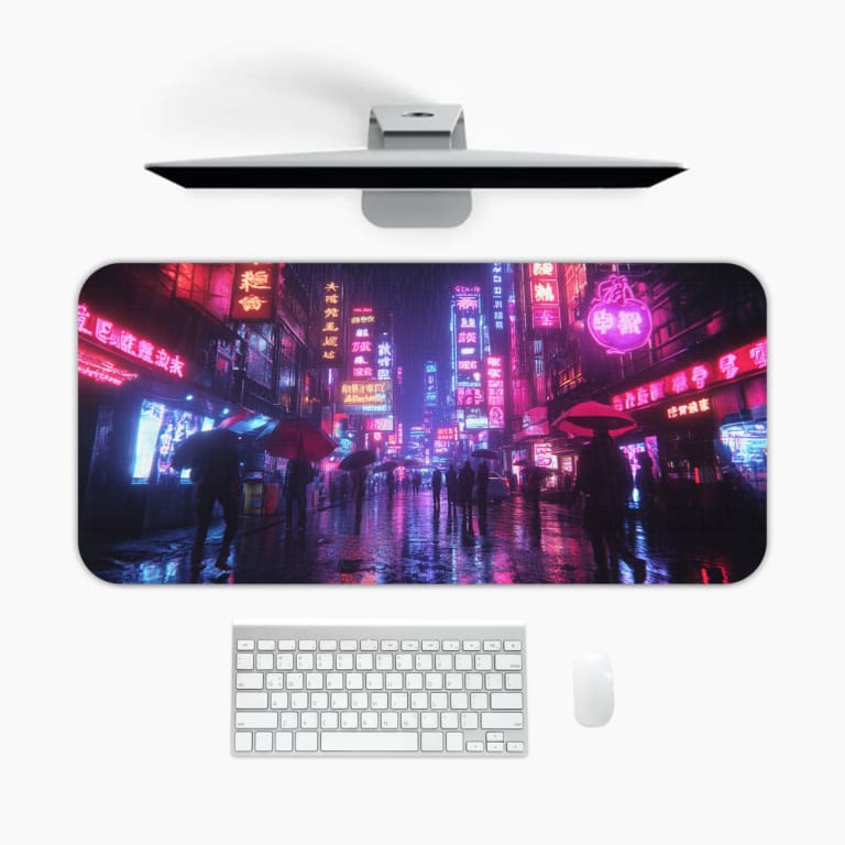 Infidu Neon Cityscape Desk Pad features a rainy night cityscape with vibrant neon lights in blue, pink, and purple tones on a dark background. A desk pad under the computer