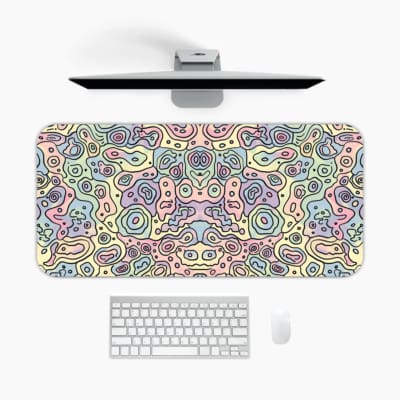 Infidu Abstract Desk Pad featuring swirling pastel patterns in pink, blue, and purple on a light off-white background. A desk pad under the computer