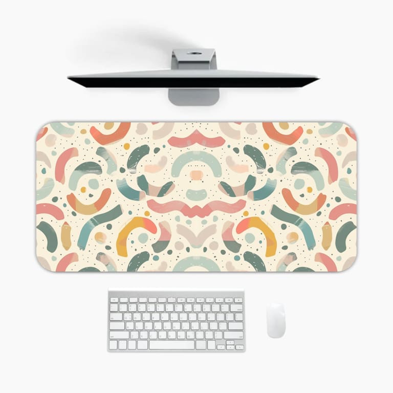 Infidu desk pad with a modern abstract pattern in muted colors on a light background, featuring curved shapes and lines. A desk pad under the computer