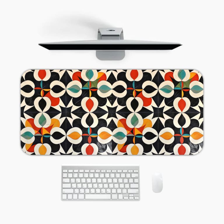 Infidu desk pad featuring a bold geometric design with vibrant colors on a black background for a modern look. A desk pad under the computer