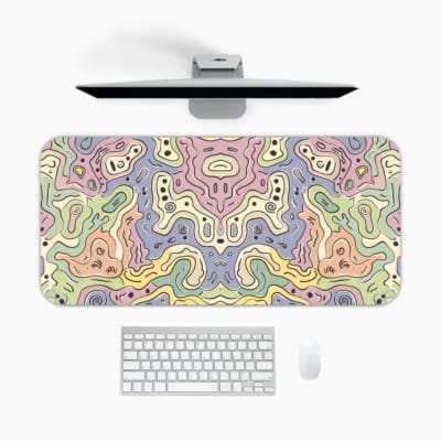 Infidu desk pad showcasing a soft pastel abstract swirling design in purple, pink, blue, green, and yellow for a calming effect. A desk pad under the computer
