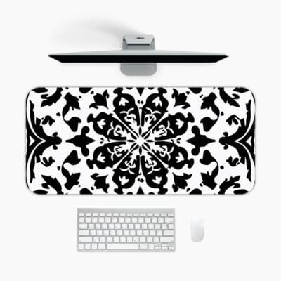 Infidu desk pad with an elegant black and white mandala design featuring intricate patterns on a white background. A desk pad under the computer