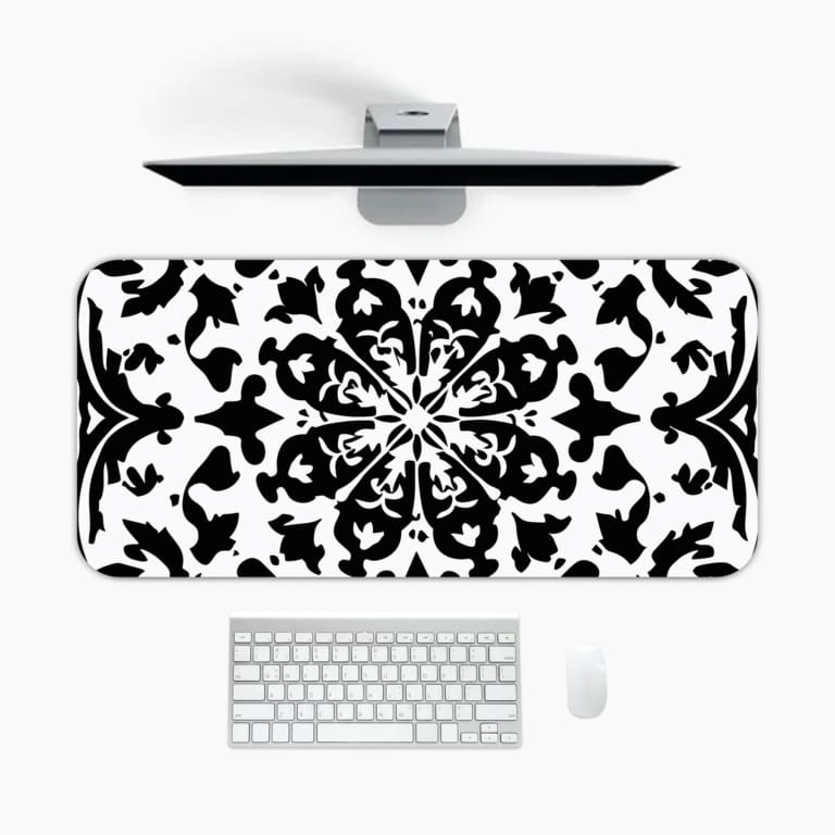 Infidu desk pad with an elegant black and white mandala design featuring intricate patterns on a white background. A desk pad under the computer