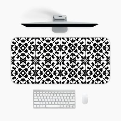 Infidu desk pad with a classic black and white floral pattern featuring detailed shapes on a white background. A desk pad under the computer