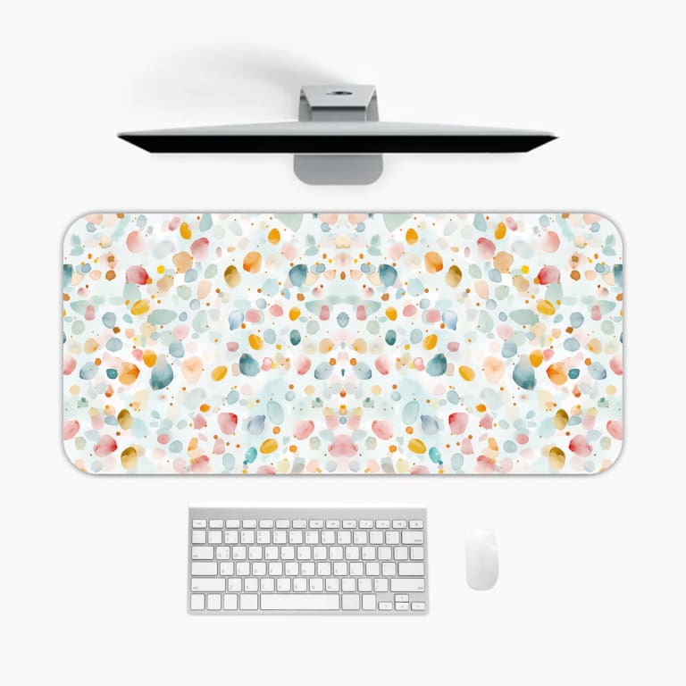 Infidu Pastel Desk Pad with light background and soft abstract shapes in pastel colors like pink, blue, yellow, and green. A desk pad under the computer