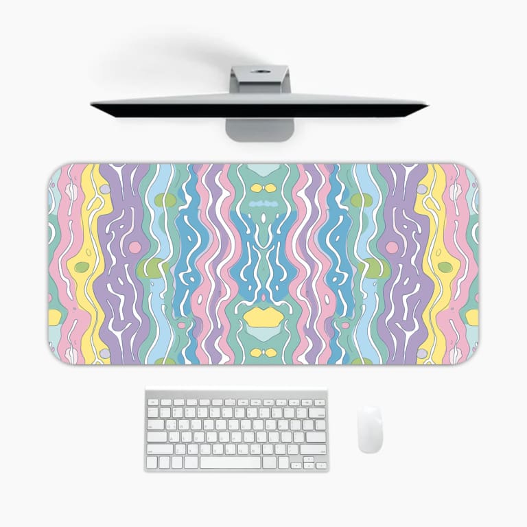 Infidu Wavy Desk Pad featuring a calm pastel ripple design in light blue, purple, pink, yellow, and green colors on a blended background. A desk pad under the computer