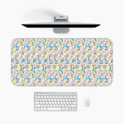 Infidu Wavy Desk Pad showcases colorful curved lines in shades of blue, yellow, and green against a light background. A desk pad under the computer