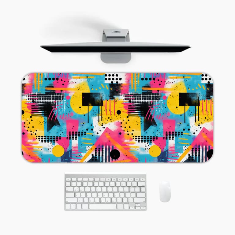 Infidu Vibrant Abstract Desk Pad featuring colorful geometric shapes on a black and white background with grid and dot patterns. A desk pad under the computer