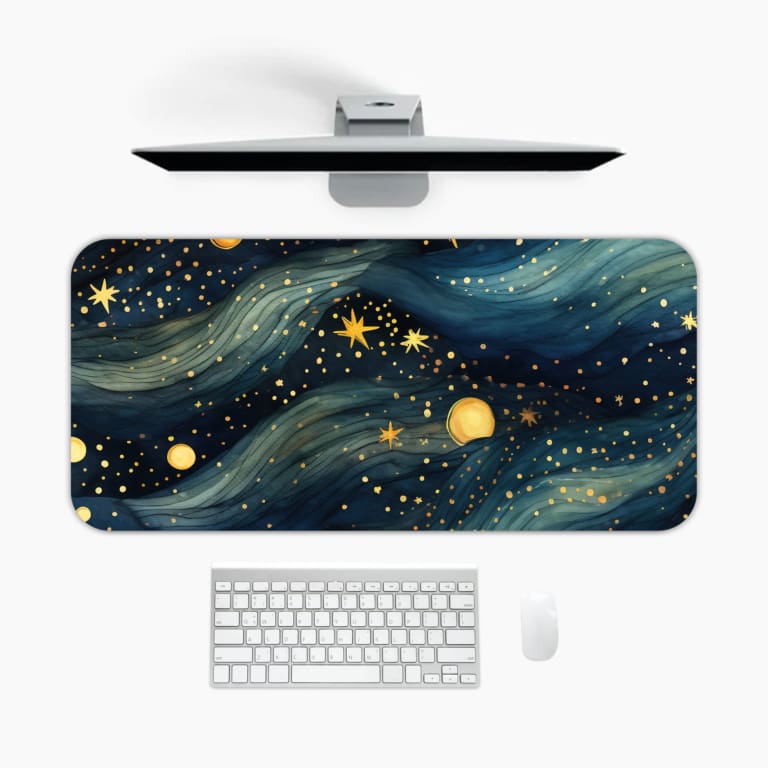 Infidu Galaxy Desk Pad with a cosmic design featuring swirling blue and white patterns, stars, and planets on a dark background. A desk pad under the computer