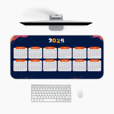 Desk pad with dark blue background, yellow "2025," orange-bordered calendar layout, and pink and purple accents A desk pad under the computer