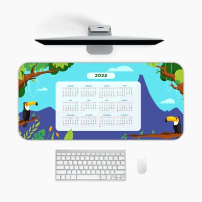2025 calendar desk pad with a light blue background, tropical landscape, green trees, colorful toucans, and nature-themed design A desk pad under the computer