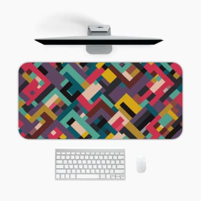 Infidu colorful geometric desk pad with bold blocks in red, teal, mustard, and maroon on a white background.