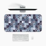 Infidu desk pad with bold geometric shapes in cool tones of blue, black, white, and purple.